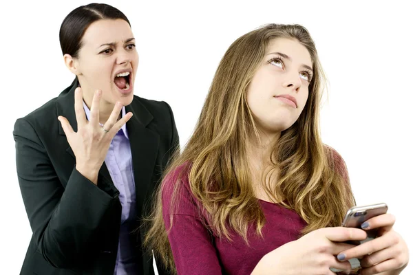 Mother shouting and yelling at daughter chatting with phone — Stock Photo, Image