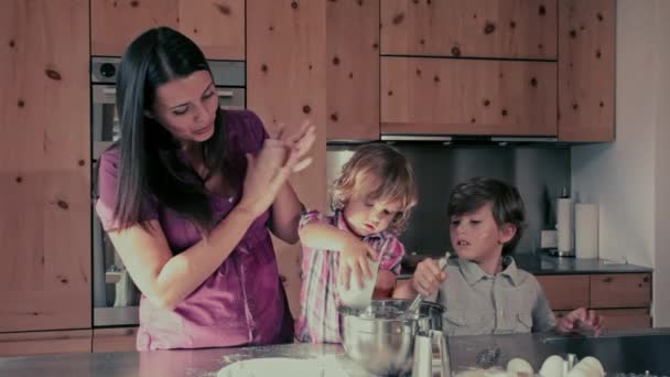 Mãe fazendo um bolo com seus filhos felizes — Vídeo de Stock
