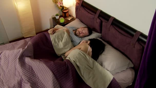 Пара спит в постели ночью мирно — стоковое видео