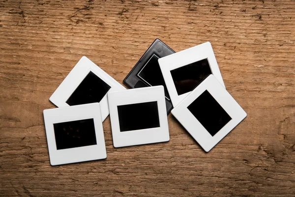 Old slides on wood background — Stock Photo, Image