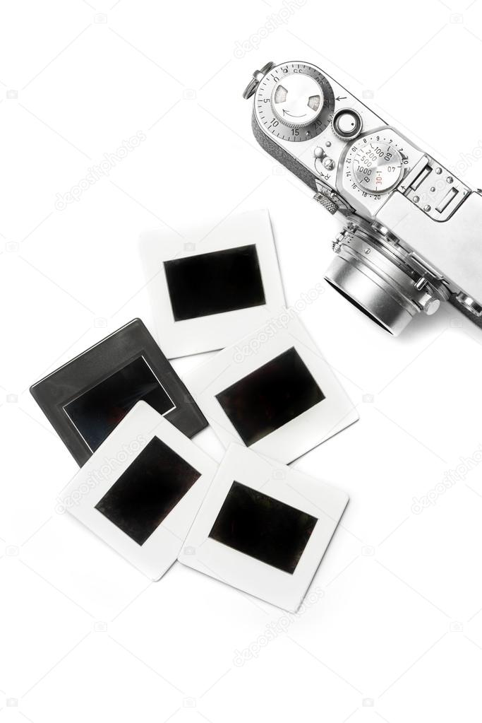 old camera and slides on white background