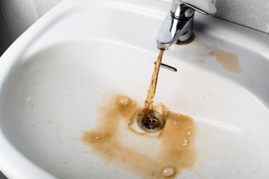 Bir lavabo içine çalışan kirli kahverengi su