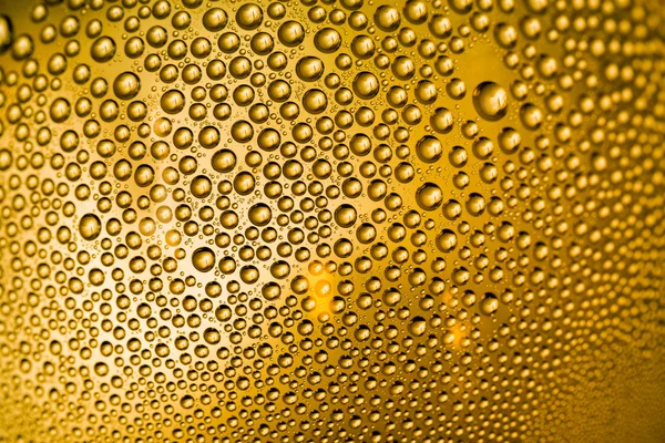 Gotas de naranja amarilla en una botella o vaso — Foto de Stock