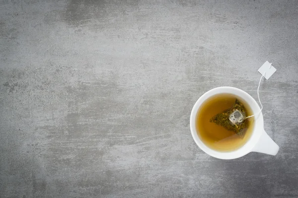 Copa de té con bolsita de té —  Fotos de Stock