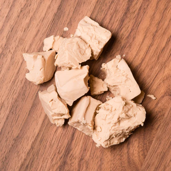 Yeast on walnut table — Stock Photo, Image