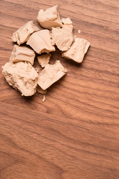 Yeast on walnut table — Stock Photo, Image