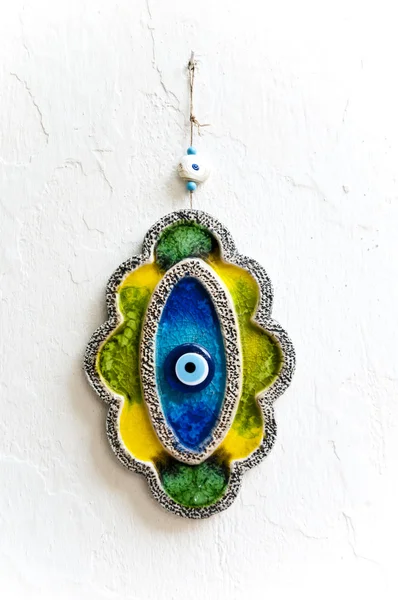 Old Ceramic Evil Eye amulet on the wall protect to bad luck and Nazar — Stock Photo, Image