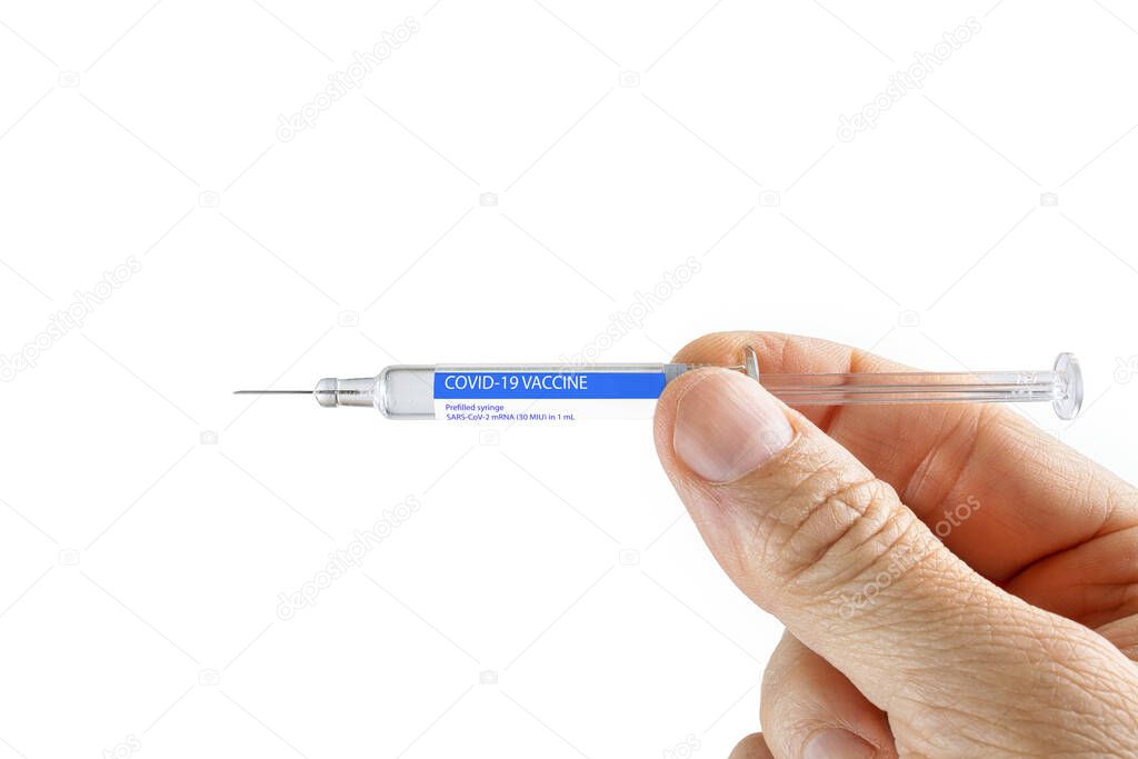 Doctor holding a prefilled COVID-19 vaccine syringe. Mock up covid virus vaccine, medicine, pharmaceutical research and health care concept.