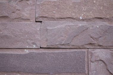 Açık kahverengi dikdörtgen kesim granit taşlar duvar yakın çekim. 