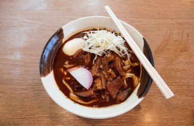 Bir kase Kishimen düz şehriye ile yemek çubuğu - yerel Nagoya Kihimen noodle Miso çorbası, tofu, domuz göbeği ile dilimlenmiş Kamaboko balık keki, yumurta, pırasa.