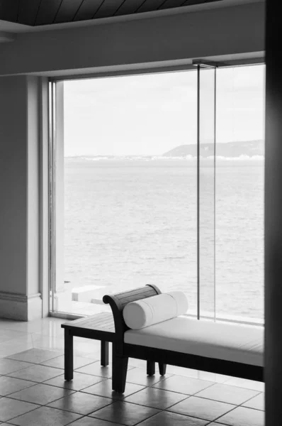 Asian Contemporary style daybed with ocean view through bay window in black and white