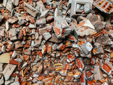 İnşaat alanındaki kırık kırmızı tuğla ve beton yığını detayları kapat - yıkım kavramı