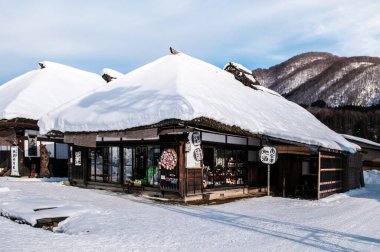 24 Ocak 2014 Fukushima, Japonya: Ouchi Juku köyü, Fukushima, Tohoku, Japonya 'da kışın çatılı ev, klasik ev ve karla kaplı cadde