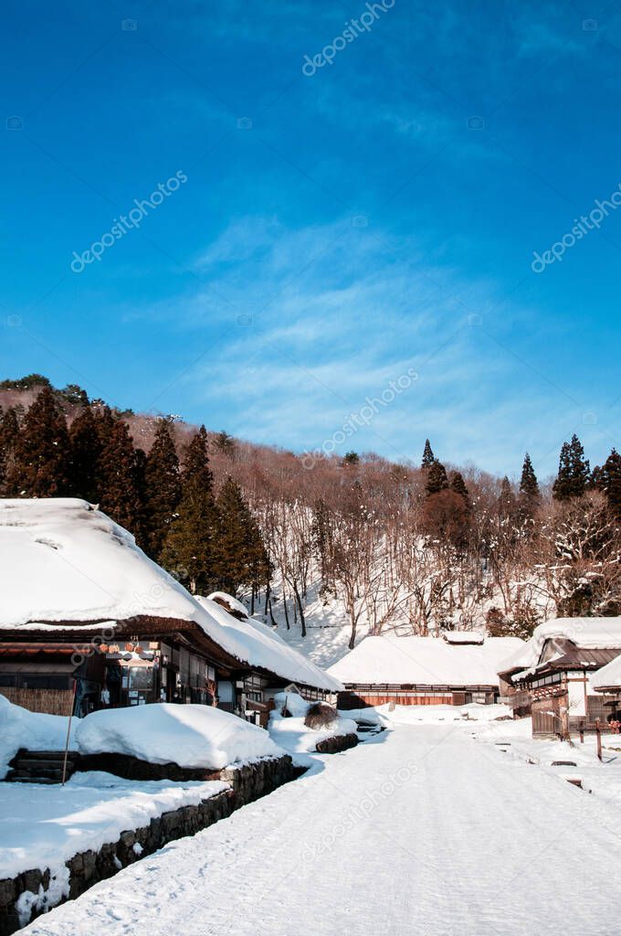 JAN 24, 2014 Fukushima, Japan : Thatched roof house, vintage house and snow covered street in Ouchi Juku village, Fukushima, Tohoku, Japan in Winter