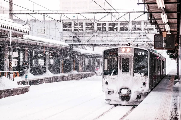 stock image JAN 23, 2014 : Sakata, Yamagata, Japan : Pink strip JR East 701 Series commutor train at Sakata Station in winter, EMU train opperated on Ou Main Line between Akita and Aomori