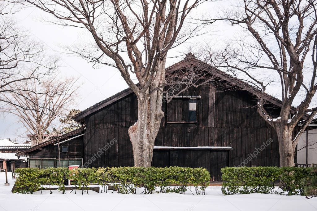 Vintage old Japanese black warehouse in winter snow, Sakata Sunkyo Soko, Yamagata  orefecture, Japan