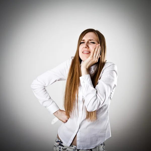 Toothache. Woman in white is having a toothache or headache Stock Picture