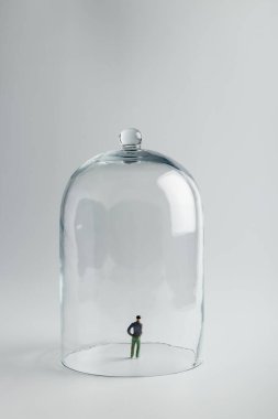 Karantinada, cam bir kubbenin altında fotokopi alanı olan parlak bir zemin üzerinde küçük bir heykel. Coronavirus önleme, sosyal uzaklık ve karantina kavramı. Kişisel izolasyon.