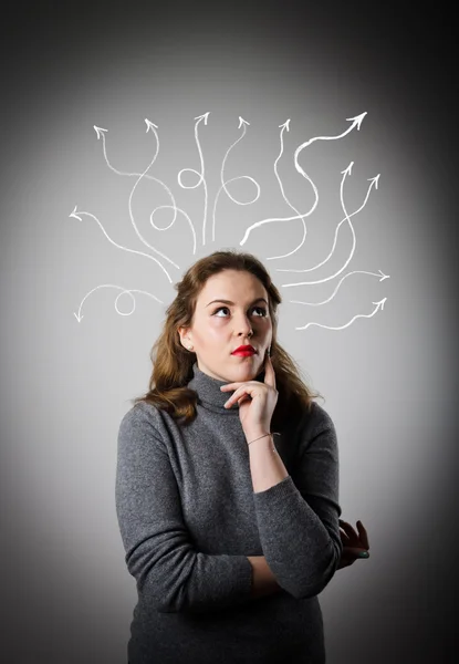 Girl in grey is thinking. Girl in grey and arrows. — Stock Photo, Image