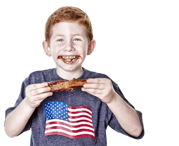 Boy eating BBQ rib — Stock Photo, Image