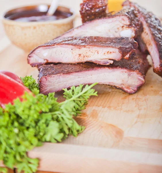 Fresh BBQ ribs on a wooden board — Stock Photo, Image