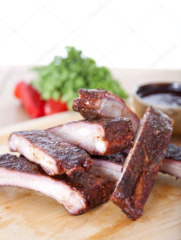 Fresh BBQ ribs on a wooden board