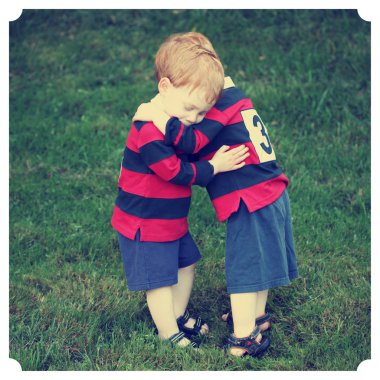 Twin baby boys hugging clipart