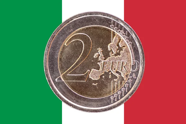 Common face of two euro coin on flag of Italy — Stock Photo, Image