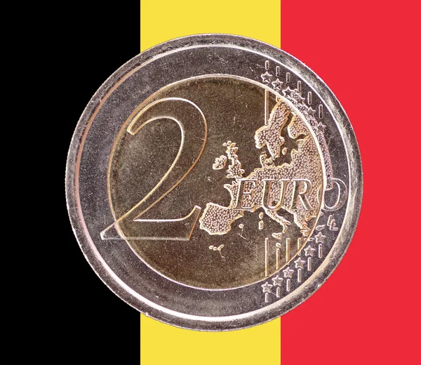 Common face of two euro coin on flag of Belgium — Stock Photo, Image