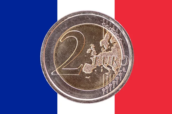 Common face of two euro coin on flag of France
