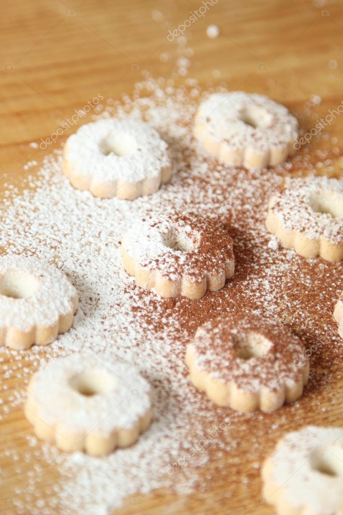 Italian canestrelli biscuits sprinkled with powdered sugar and cocoa