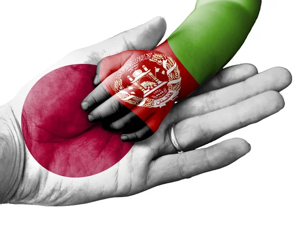 Adult man holding a baby hand with Japan and Afghanistan flags overlaid. Isolated on white — Stock fotografie