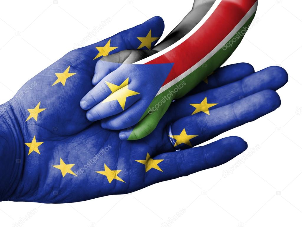 Adult man holding a baby hand with European Union and South Sudan flags overlaid. Isolated on white