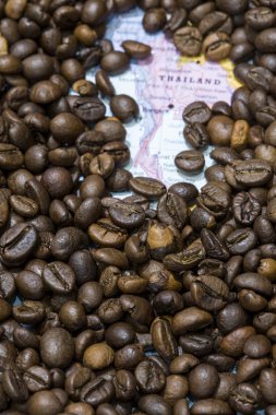 Map of Thailand under a background of coffee beans