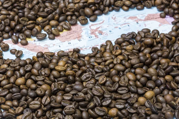 Map of Indonesia under a background of coffee beans — Stockfoto