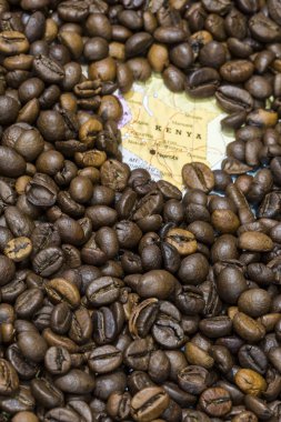 Map of Kenya under a background of coffee beans