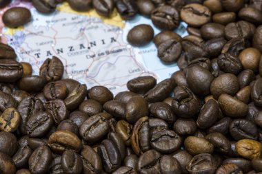 Map of Tanzania under a background of coffee beans