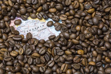 Map of Tanzania under a background of coffee beans