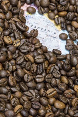 Map of Tanzania under a background of coffee beans