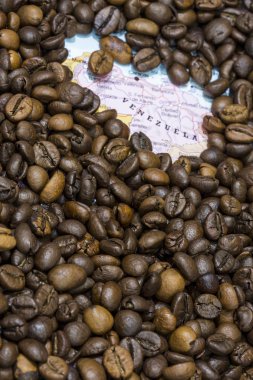 Map of Venezuela under a background of coffee beans