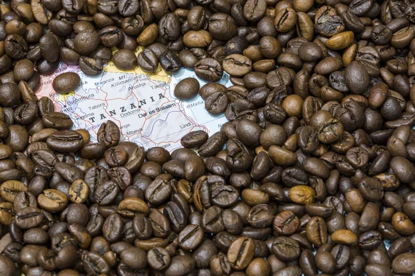 Map of Tanzania under a background of coffee beans — Stockfoto