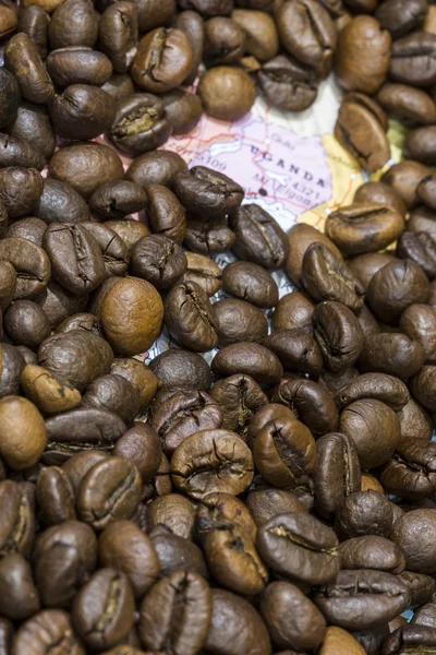 Map of Uganda under a background of coffee beans — Stockfoto