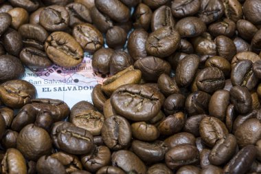 Map of El Salvador under a background of coffee beans