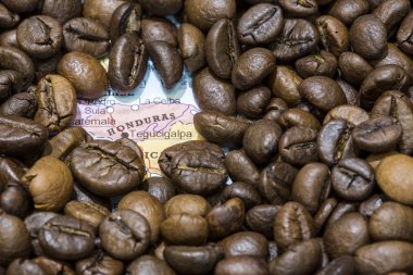 Map of Honduras under a background of coffee beans