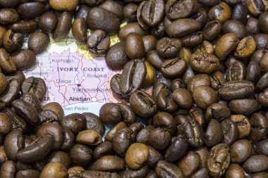 Map of Ivory Coast under a background of coffee beans