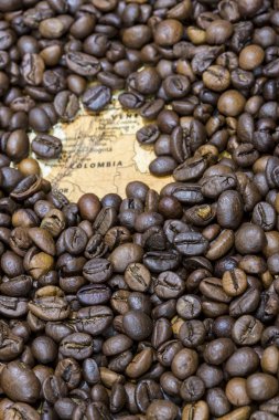 Map of Colombia under a background of coffee beans