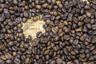 Map of Colombia under a background of coffee beans