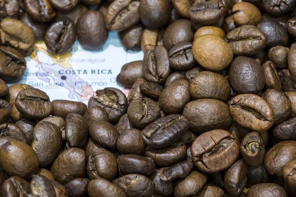 Map of Costa Rica under a background of coffee beans — Stockfoto