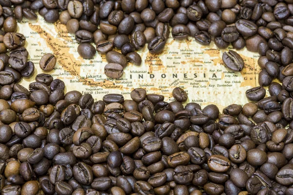 Map of Indonesia under a background of coffee beans — Stockfoto