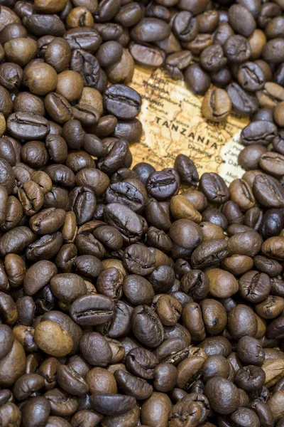 Map of Tanzania under a background of coffee beans — Stockfoto